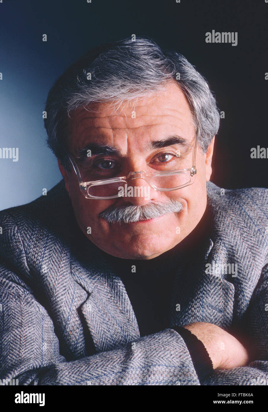 Studio portrait of distinquished older gentleman with eyeglasses, mustache & grey hair Stock Photo