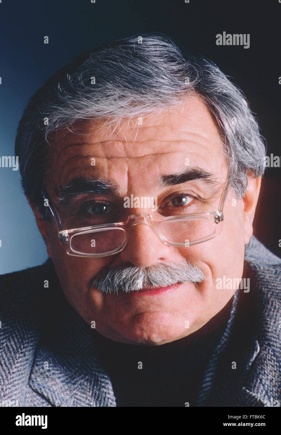 Studio portrait of distinquished older gentleman with eyeglasses, mustache & grey hair Stock Photo