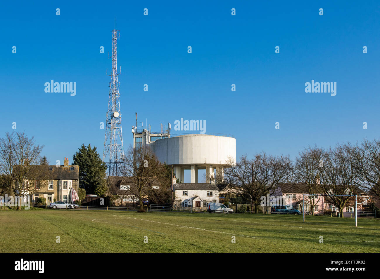 View of radio mast and water tower in Haddenham, Cambridgeshire Stock Photo