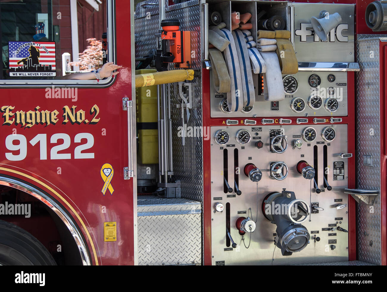 Detail of a fire engine's hoses and water pumping controls on display ...