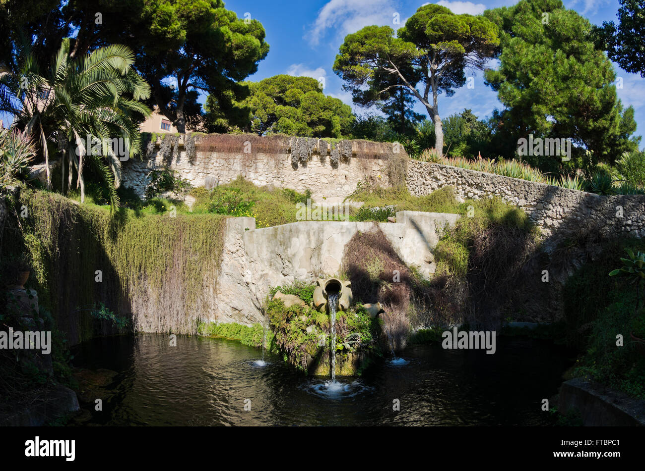 Fountain in a park with water flowing from an old amphora, Cagliari, Sardinia Stock Photo