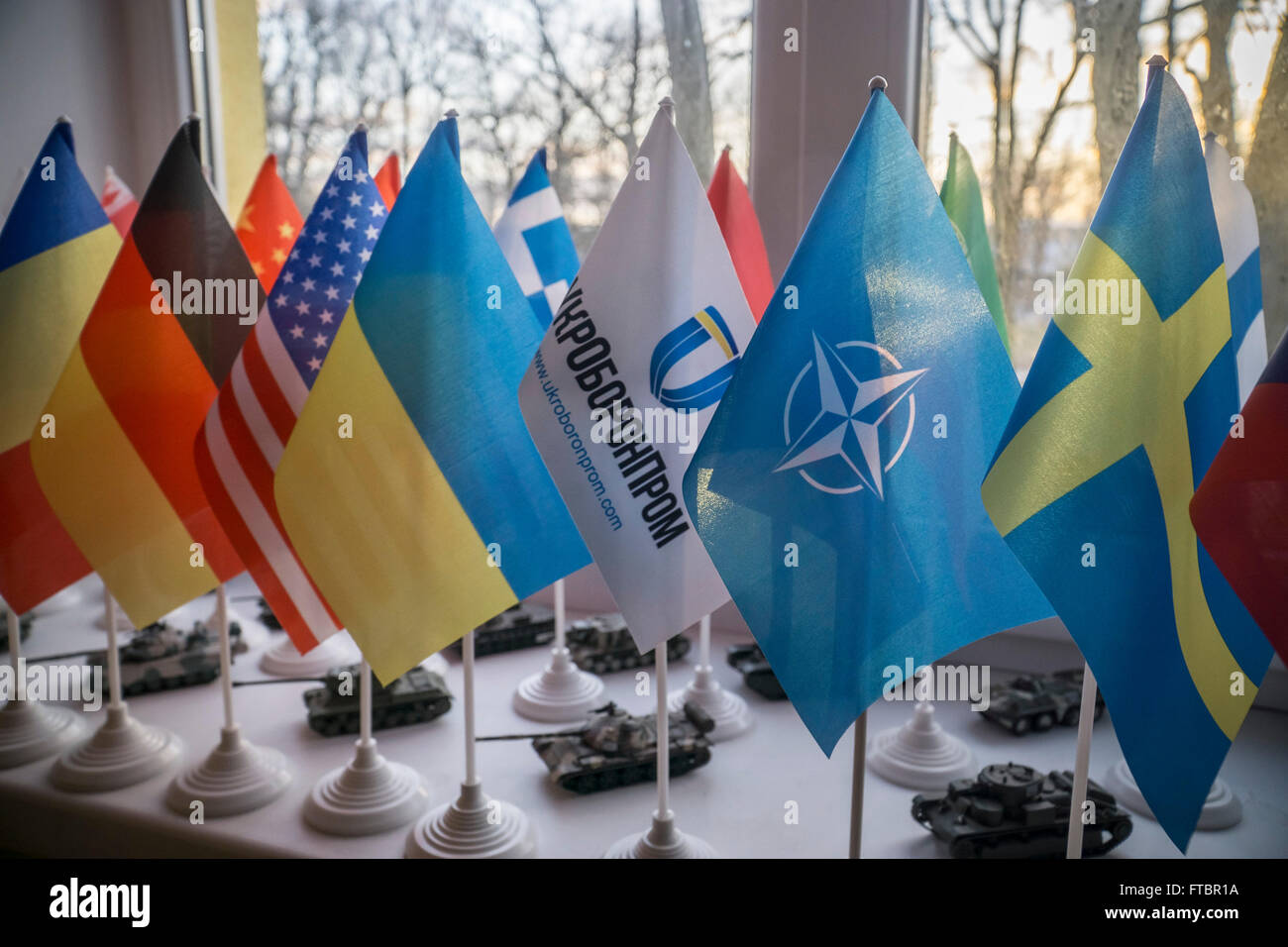 Mini flags of Ukroboronprom, USA, NATO, Germany and Sweden are seen in an office in the Lviv Armour Plant Stock Photo