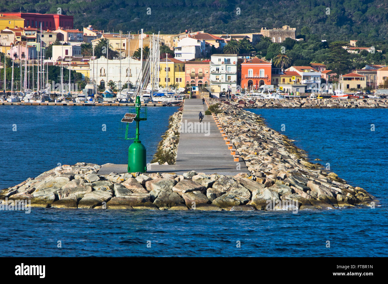 Small green lighthouse at entrance to Carloforte harbor at San Pietro island, Sardinia Stock Photo