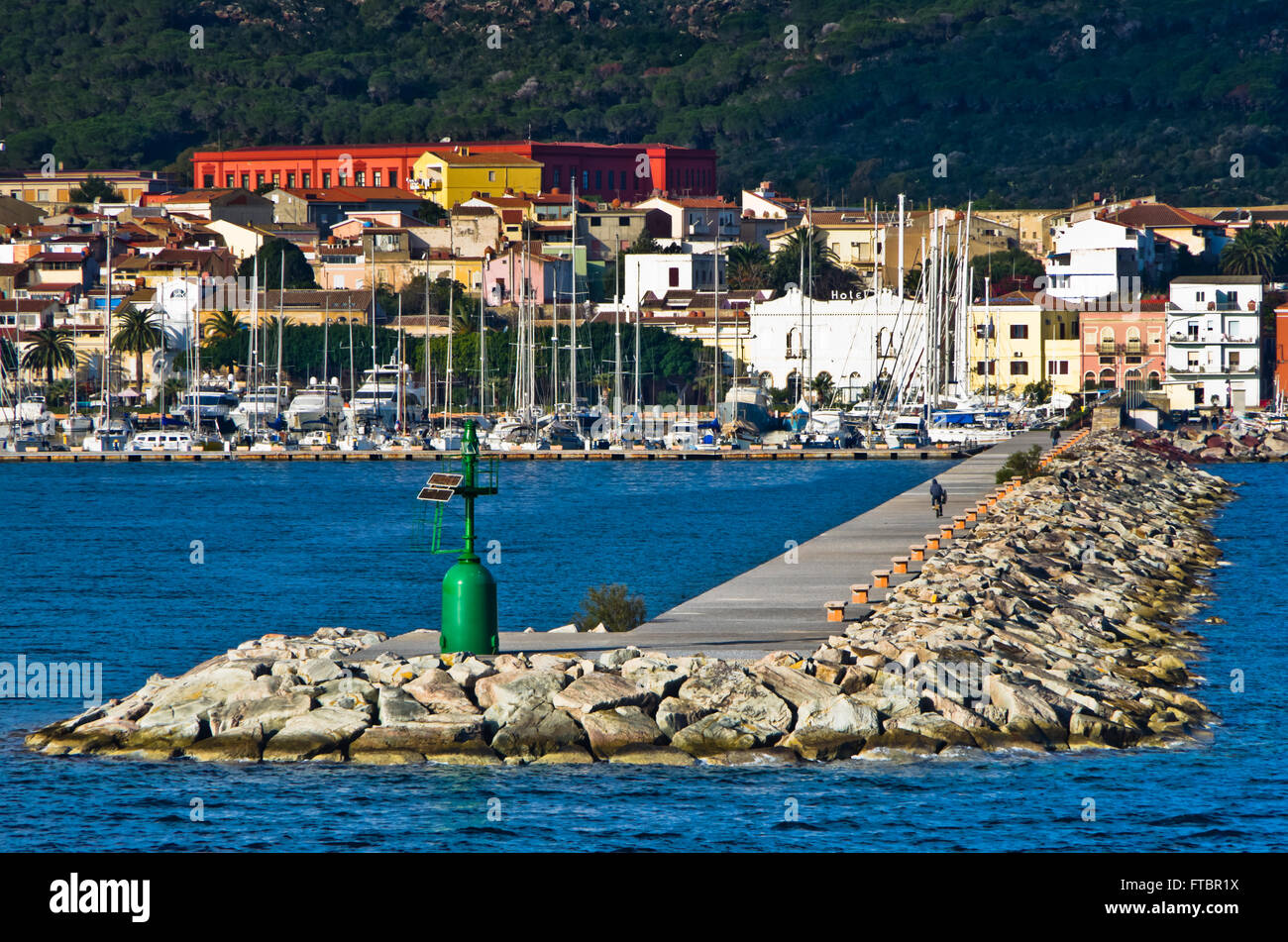 Small green lighthouse at entrance to Carloforte harbor at San Pietro island, Sardinia Stock Photo