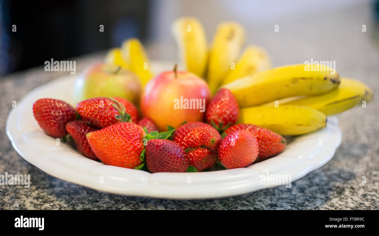 strawberries and banana with two apples on food plate Stock Photo Alamy