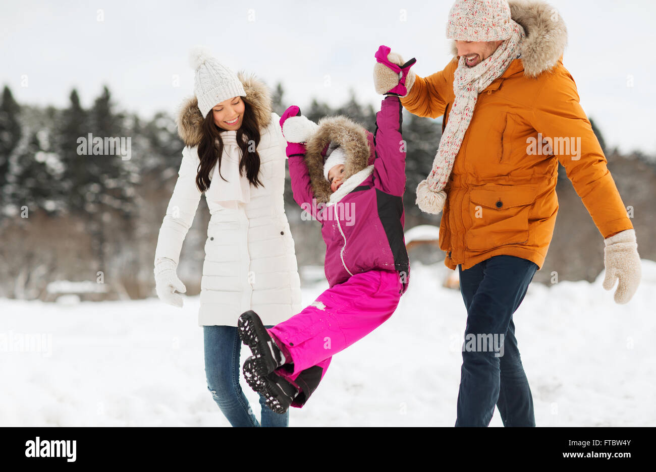 happy family in winter clothes walking outdoors Stock Photo - Alamy