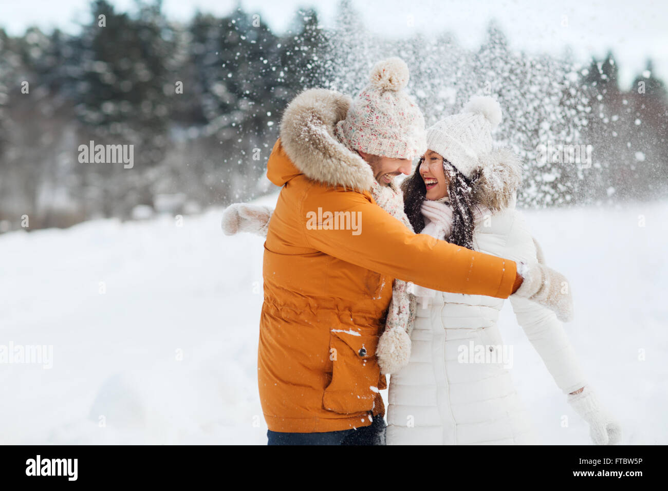happy couple hugging and laughing in winter Stock Photo - Alamy