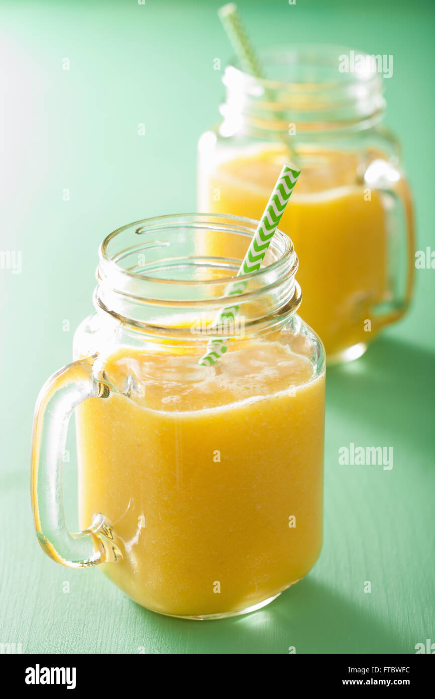healthy mango pineapple smoothie in mason jars Stock Photo