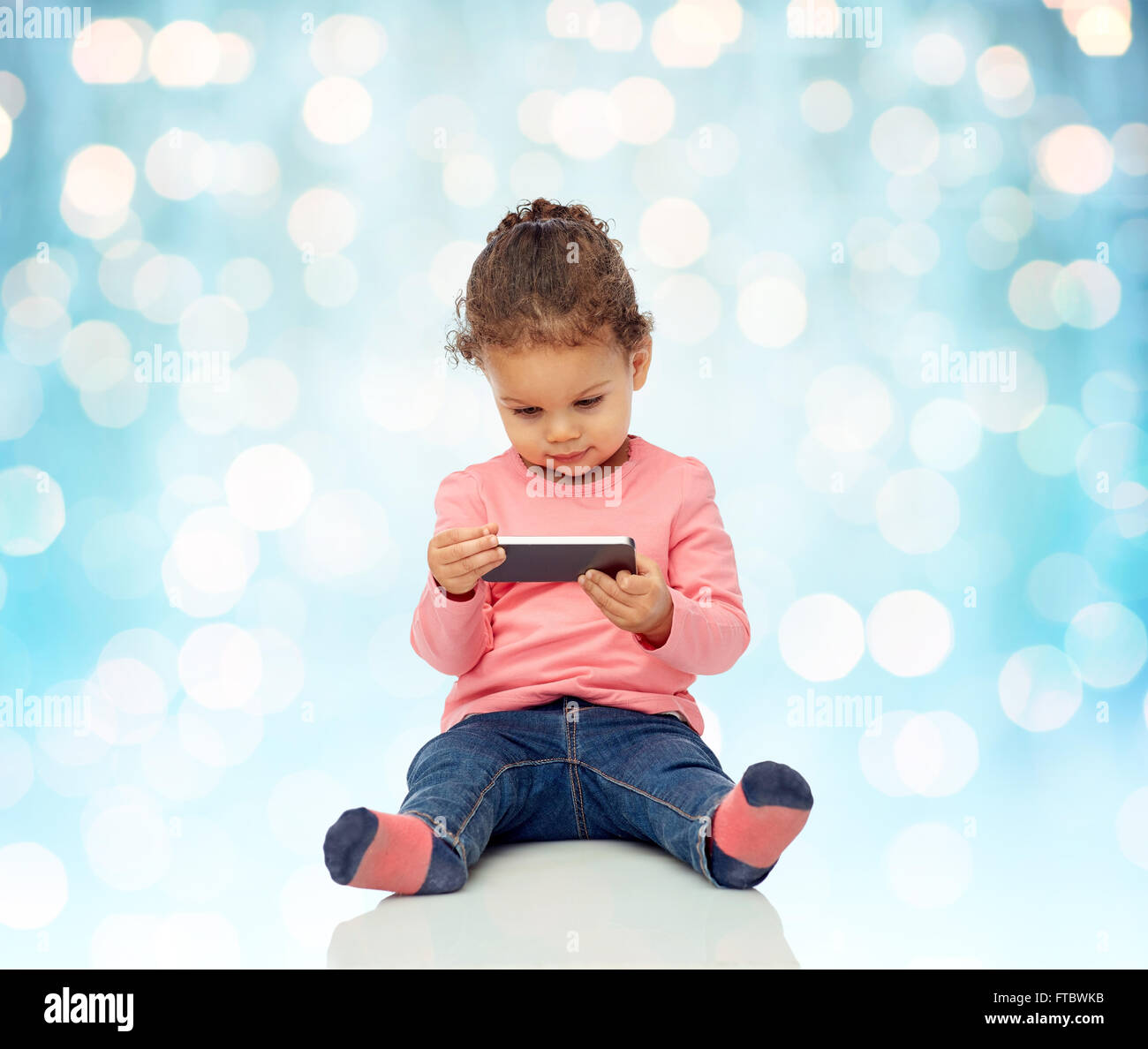 smiling little baby girl playing with smartphone Stock Photo - Alamy