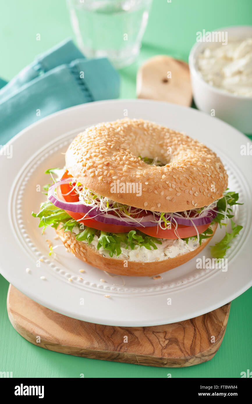 tomato sandwich on bagel with cream cheese onion lettuce alfalfa