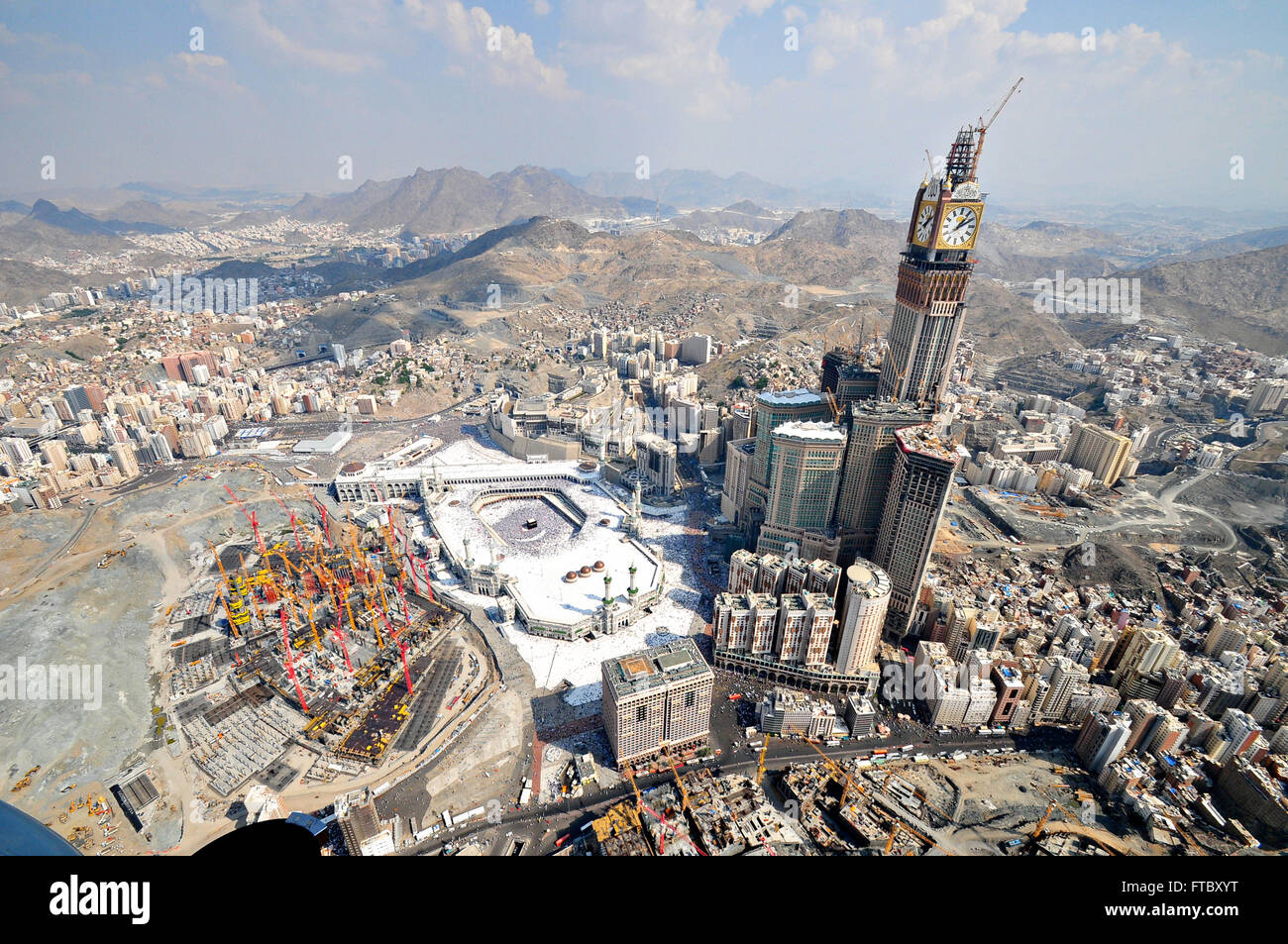 Aerial view of the Holy Kaaba in the Al-Masjid al Haram with the skyline and construction of the clock tower in Mecca, al-Hejaz, Saudi Arabia. Stock Photo