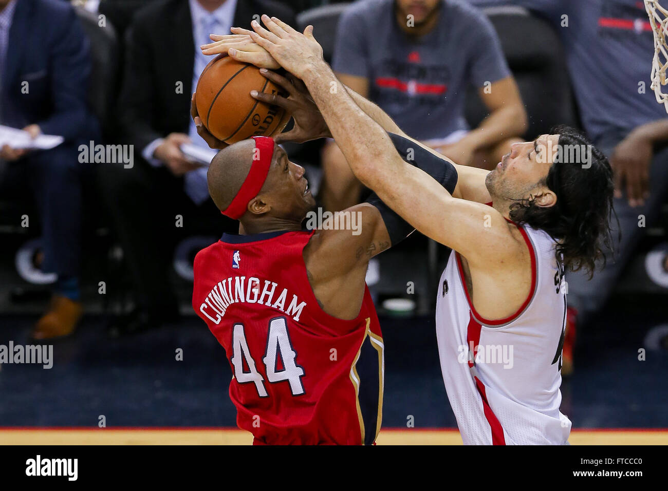 New Orleans, LA, USA. 26th Mar, 2016. New Orleans Pelicans forward Dante Cunningham (44) is fouled by Toronto Raptors forward Luis Scola (4) during an NBA basketball game between the Toronto Raptors and the New Orleans Pelicans at the Smoothie King Center in New Orleans, LA. Stephen Lew/CSM/Alamy Live News Stock Photo