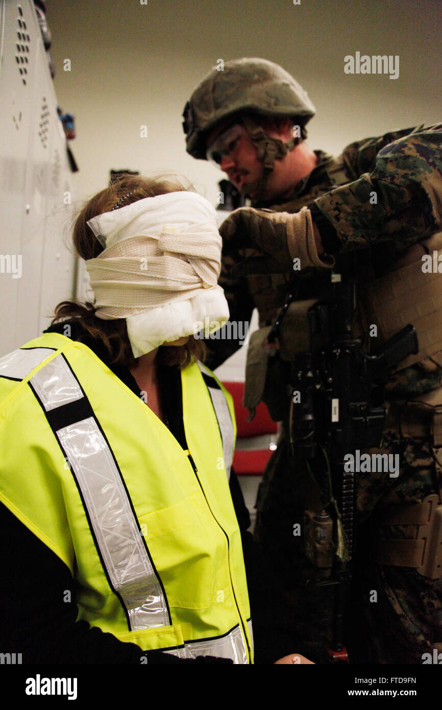 150227-M-XZ244-313 BUCHAREST, Romania (Feb. 27, 2015) U.S. Navy Hospital Corpsman 3rd Class Taylor Bennett, platoon corpsman from Alpha Fleet Anti-terrorism Security Team Company Europe (FASTEUR), Naval Station Rota, Spain, treats a simulated facial injury during a mass casualty drill, part of an embassy engagement at the U.S. Embassy  Bucharest, Romania, Feb. 27, 2015. The embassy engagement provided FASTEUR Marines a chance to conduct training on reinforcing an American embassy with host nation forces in case of a crisis. (U.S. Marine Corps photo by Sgt. Esdras Ruano/Released) Stock Photo