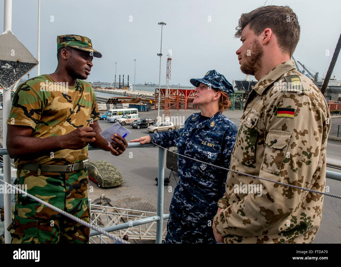 150318-N-EZ054-169 TEMA, Ghana (March 18, 2015) Ghana air force Master Sgt. Elvis Gauch, left,  speaks with Chief Hospital Corpsman Allison Levy, from Bradenton, Fla., center,and a German navy sailor regarding medical procedures and techniques during a visit, board, search and seizure training evolution during Exercise Obangame Express 2015 aboard  GNS Bonsu March 18, 2015. Obangame Express 2015, sponsored by U.S. Africa Command (AFRICOM), is designed to improve regional cooperation, maritime domain awareness (MDA), information-sharing practices, and tactical interdiction expertise to enhance  Stock Photo