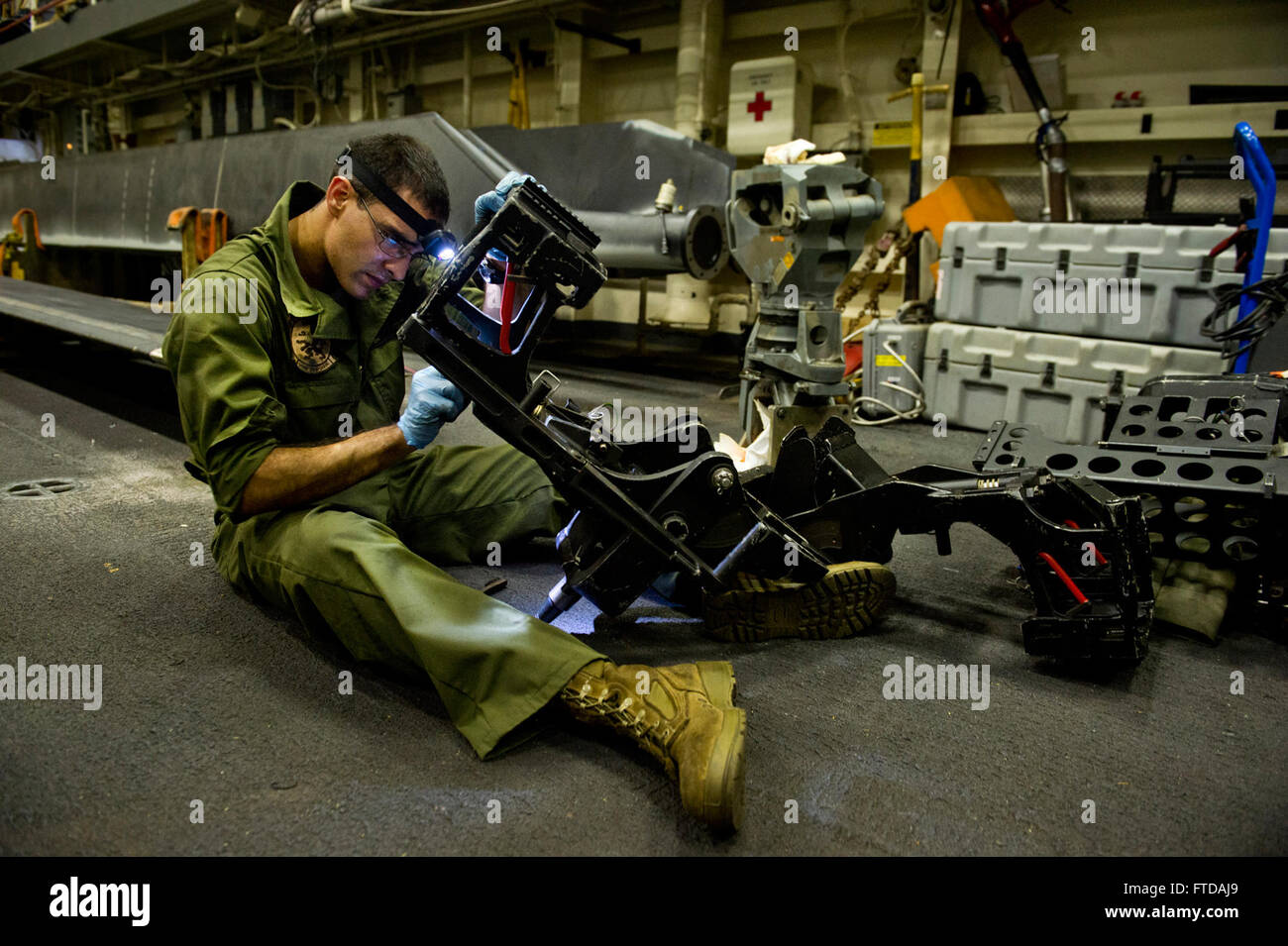 130910-N-WX580-012 MEDITERRANEAN SEA (Sept. 10, 2013) Cpl. Edwin Rolon from the 26th Marine Expeditionary Unit (MEU) performs maintenance on an MH-53E Super Stallion’s .50-caliber gun mount in the hangar bay of the amphibious transport dock ship USS San Antonio (LPD 17). San Antonio is deployed as part of the Kearsarge Amphibious Ready Group and with the embarked 26th Marine Expeditionary Unit, is deployed in support of maritime security operations and theater security cooperation efforts in the U.S. 6th Fleet area of operations. (U.S. Navy photo by Mass Communication Specialist 3rd Class Laco Stock Photo