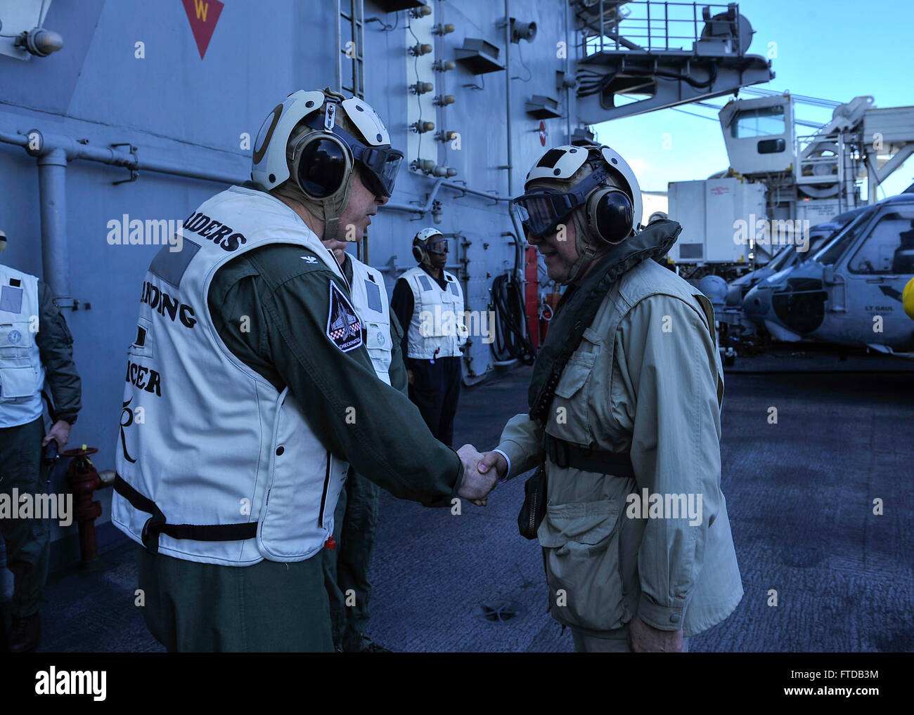 150403-N-GR120-271 MEDITERRANEAN SEA (April 03, 2015) - Capt. Daniel C. Grieco, commanding officer of the Nimitz-class aircraft carrier USS Theodore Roosevelt (CVN 71) greets U.S. Ambassador to Greece, David D. Pearce, arriving on the TR, April 03, 2015. Theodore Roosevelt hosted Pearce, and other senior Greek government and military officials  as part of the distinguished visitors program. Theodore Roosevelt deployed from Norfolk and will execute a homeport shift to San Diego at the conclusion of deployment. Theodore Roosevelt is conducting naval operations in the U.S. 6th Fleet area of opera Stock Photo