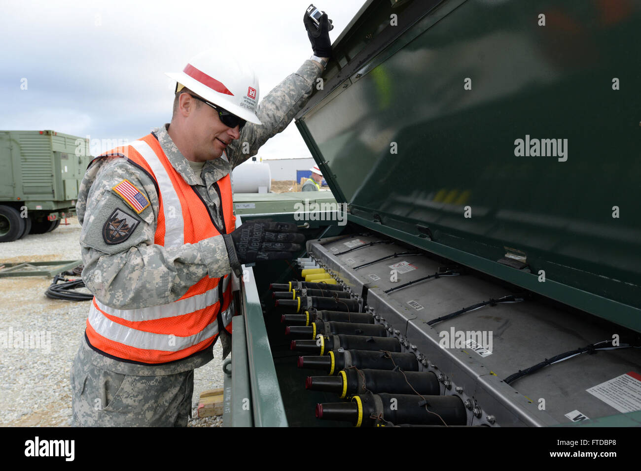 150419-N-TQ904-073 NAVAL SUPPORT FACILITY DEVESELU, Romania (April 19, 2015) Sgt. 1st Class Aaron Norris, from Millersport, Ohio, inspects an electrical switching box at Naval Support Facility Deveselu, Romania, April 19, 2015. Norris, a member of the 249th Engineer Battalion from Fort Belvoir, Virginia, helped install four portable generators at Deveselu’s Aegis Ashore facility. (U.S. Navy photo by Lt. Cmdr. Mike Billips/Released) Stock Photo
