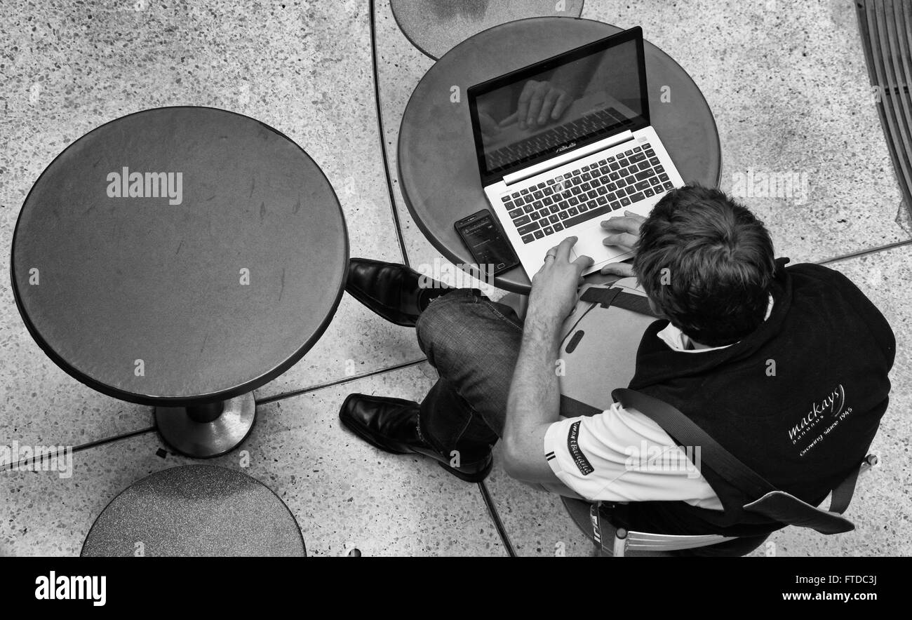 man using laptop in lunch break Stock Photo