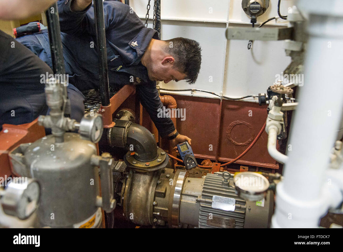 150518-N-XB010-179 MEDITERRANEAN SEA (May 18, 2015) Hull Technician 1st Class Jesse James, from Langlois, Oregon, takes a chemical level reading of an aft vacuum, collection, holding and transfer pump in a main shaft space aboard USS Laboon (DDG 58) May 18, 2015. Laboon, an Arleigh Burke-class guided-missile destroyer, homeported in Norfolk, is conducting naval operations in the U.S. 6th Fleet area of operations in support of U.S. national security interests in Europe. (U.S. Navy photo by Mass Communication Specialist 3rd Class Desmond Parks/Released) Stock Photo