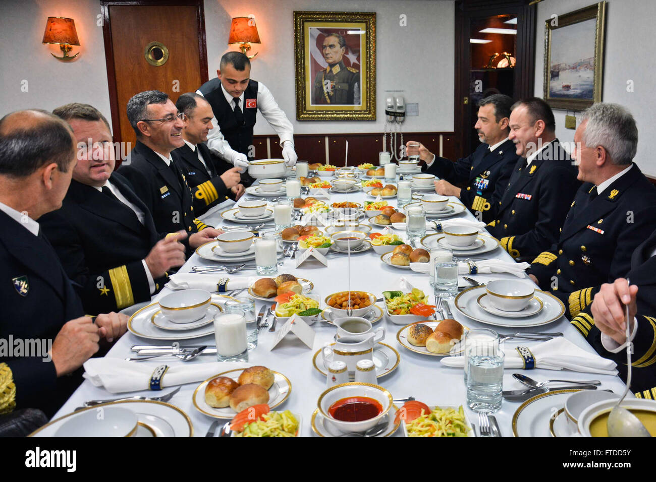 150605-N-IY633-105 GDYNIA, Poland (June 5, 2015) – Standing NATO Maritime Group 2 (SNMG2) and Polish Armed Forces leadership enjoy lunch aboard SNMG2 Turkish ship TCG Göksu (F 497) during SNMG2’s port visit to the city in preparation for exercise Baltic Operations (BALTOPS). BALTOPS is an annually reoccurring multinational exercise designed to enhance flexibility and interoperability, as well as demonstrate resolve of Allied and partner forces to defend the Baltic region. (U.S. Navy photo by Mass Communication Specialist 2nd Class Amanda S. Kitchner/Released) Stock Photo