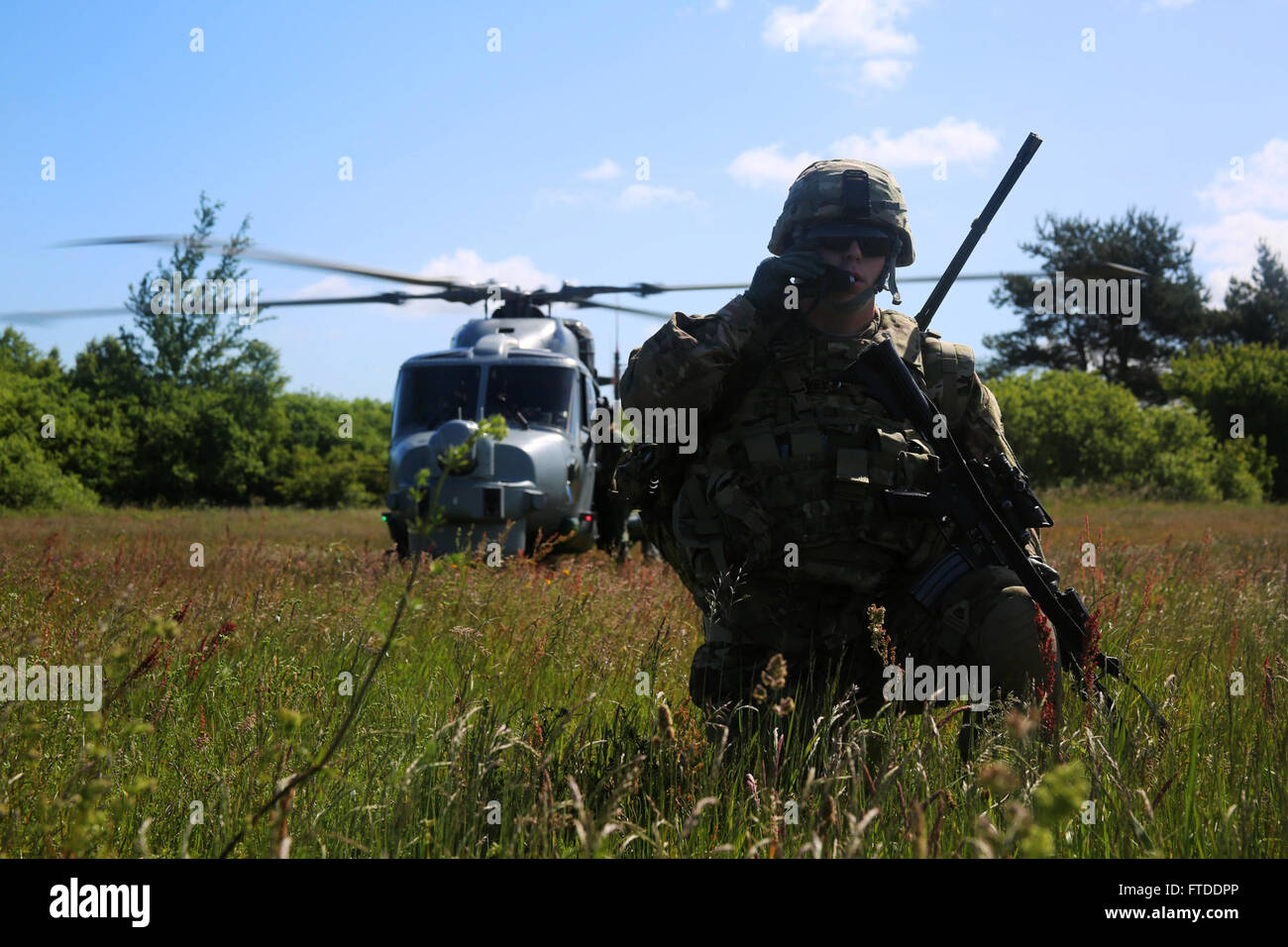 150615-M-OM669-005 POLAND (June 15, 2015) U.S. Army paratroopers from the 173d Airborne Brigade inserted into Poland via a British Royal Navy Lynx Mk-8 and conducted a personnel extraction, June 15. The mission is one of the exercise scenarios for BALTOPS 2015, an annually reoccurring multinational exercise designed to enhance flexibility and interoperability, as well as demonstrate resolve of allied and partner forces to defend the Baltic region. (Official U.S. Marine Corps photo by 1st Lt. Sarah E. Burns/Released) Stock Photo