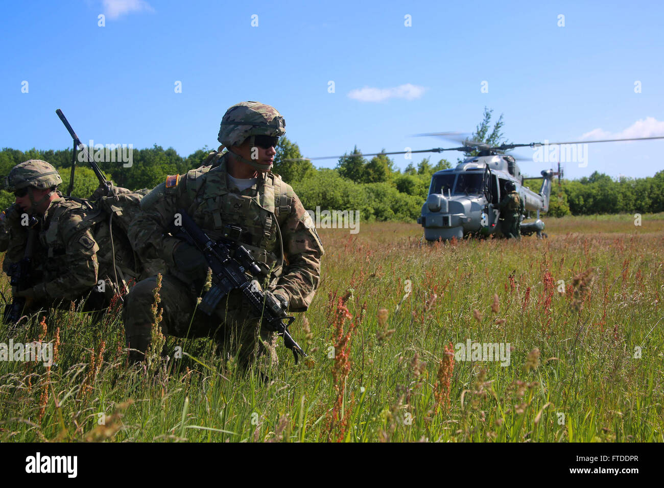 150615-M-OM669-006 POLAND (June 15, 2015) U.S. Army paratroopers from the 173d Airborne Brigade inserted into Poland via a British Royal Navy Lynx Mk-8 and conducted a personnel extraction, June 15. The mission is one of the exercise scenarios for BALTOPS 2015, an annually reoccurring multinational exercise designed to enhance flexibility and interoperability, as well as demonstrate resolve of allied and partner forces to defend the Baltic region. (Official U.S. Marine Corps photo by 1st Lt. Sarah E. Burns/Released) Stock Photo