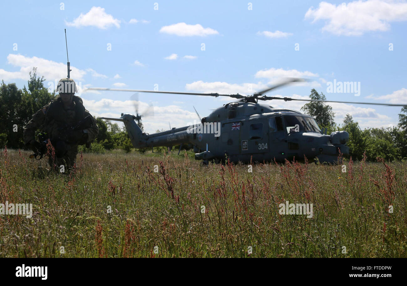 150615-M-OM669-009 POLAND (June 15, 2015) U.S. Army paratroopers from the 173d Airborne Brigade inserted into Poland via a British Royal Navy Lynx Mk-8 and conducted a personnel extraction, June 15. The mission is one of the exercise scenarios for BALTOPS 2015, an annually reoccurring multinational exercise designed to enhance flexibility and interoperability, as well as demonstrate resolve of allied and partner forces to defend the Baltic region. (Official U.S. Marine Corps photo by 1st Lt. Sarah E. Burns/Released) Stock Photo