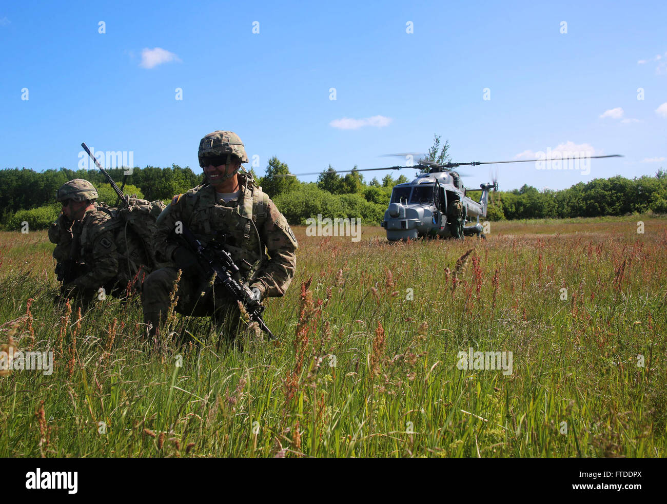 150615-M-OM669-007 POLAND (June 15, 2015) U.S. Army paratroopers from the 173d Airborne Brigade inserted into Poland via a British Royal Navy Lynx Mk-8 and conducted a personnel extraction, June 15. The mission is one of the exercise scenarios for BALTOPS 2015, an annually reoccurring multinational exercise designed to enhance flexibility and interoperability, as well as demonstrate resolve of allied and partner forces to defend the Baltic region. (Official U.S. Marine Corps photo by 1st Lt. Sarah E. Burns/Released) Stock Photo