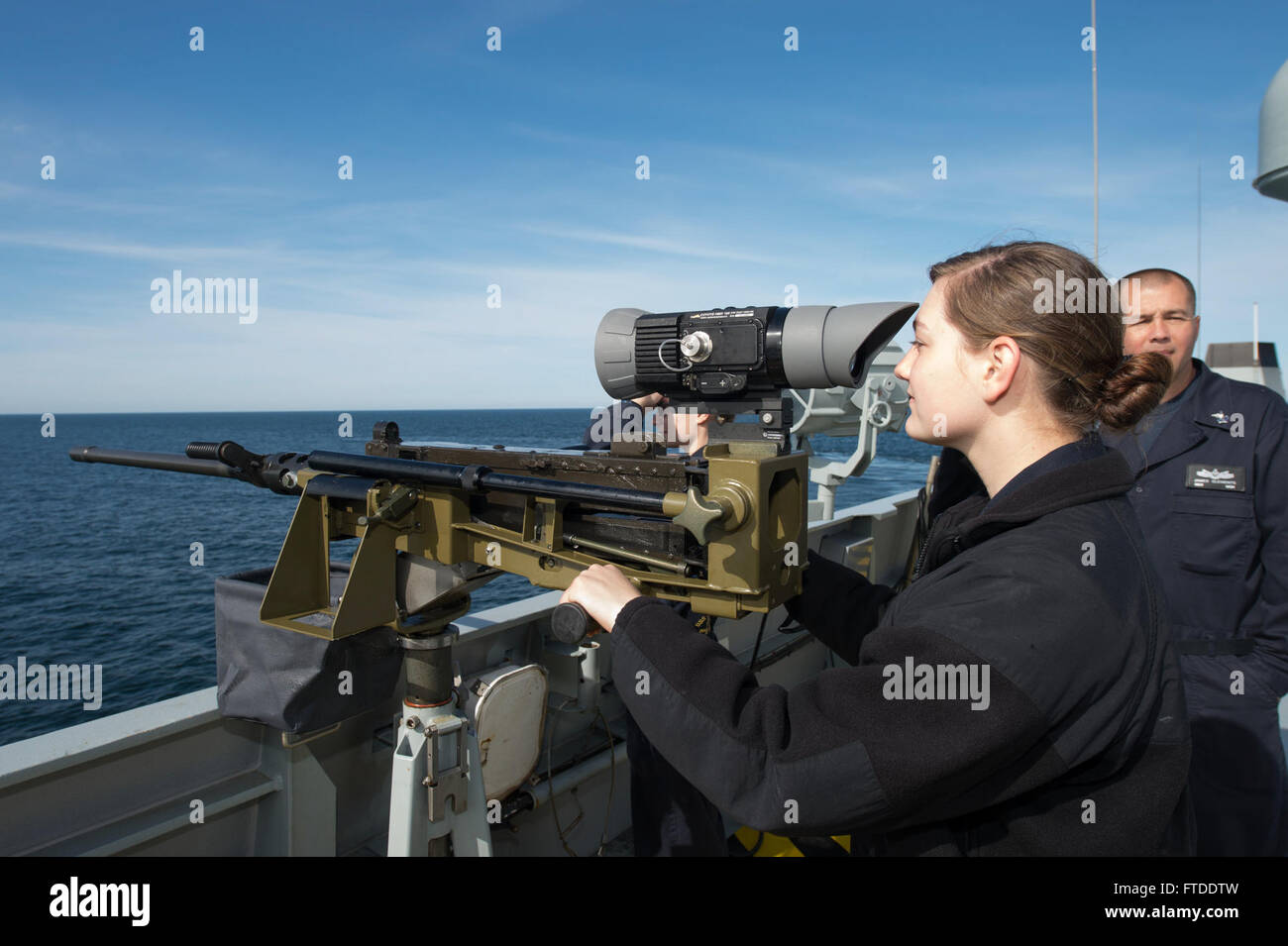 150617-N-ZE250-057 BALTIC SEA (June 17, 2015) Gunner's Mate 2nd Class Allie Enderes, assigned to USS Jason Dunham (DDG 109), looks through the thermal scope on an M2 .50 caliber machinegun during a tour of Danish Navy Frigate HDMS Absalon (L16) June 17, 2015. Jason Dunham, an Arleigh Burke-class guided-missile destroyer homeported in Norfolk, is participating in exercise Baltic Operations (BALTOPS) 2015. BALTOPS is an annually recurring multinational exercise designed to enhance flexibility and interoperability, as well as demonstrate resolve of Allied and partner forces to defend the Baltic r Stock Photo