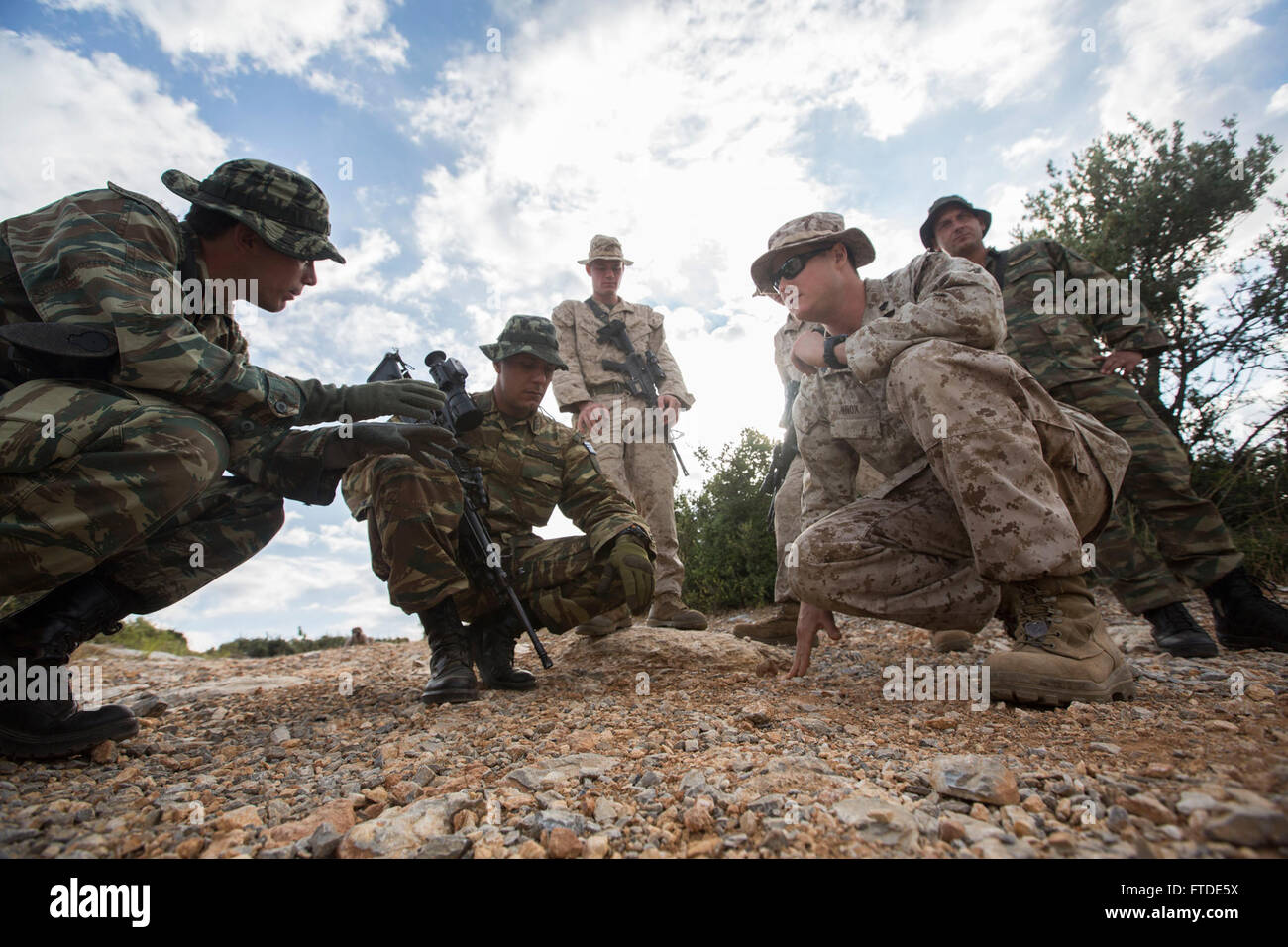 150626-M-YH418-004: VOLOS, Greece (June 26, 2015) - Sergeant James Knox, an explosive ordnance disposal technician with the 24th Marine Expeditionary Unit (MEU), gives a class on identifying IEDs to Greek Marines with the 521st Marine Battalion at a training site near Volos, Greece, June 26, 2015,as part of a bilateral training exercise . The 24th MEU is embarked on the ships of the Iwo Jima Amphibious Ready Group and is conducting naval operations in the U.S. 6th Fleet area of operations in support of U.S. national security interests in Europe. (U.S. Marine Corps photo by Cpl. Todd F. Michale Stock Photo