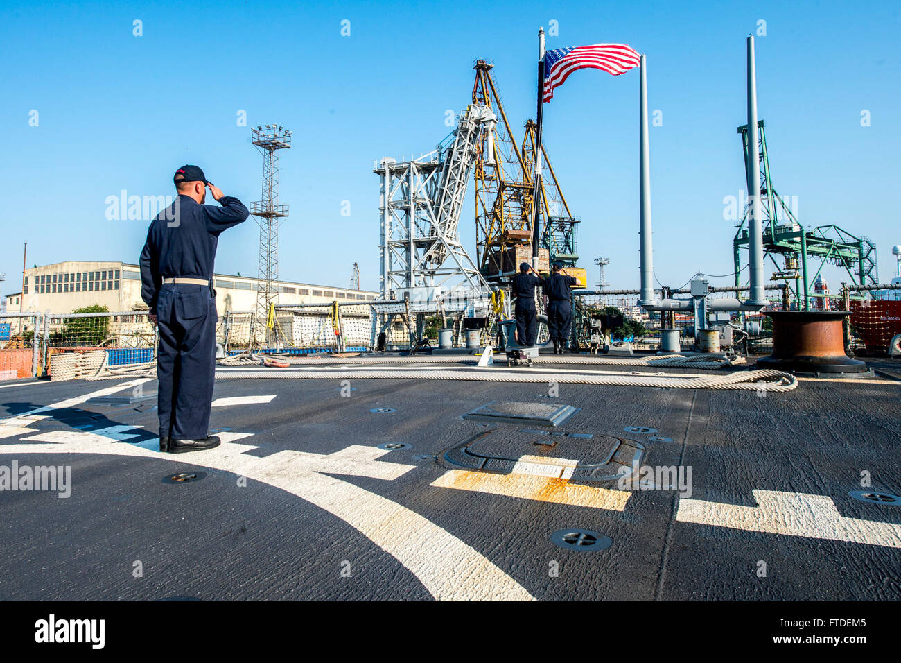 150708-N-EZ054-021 VARNA, Bulgaria (July 8, 2015) Chief Fire Controlman Daniel McCloskey, from Philadelphia, observes morning colors aboard USS Porter (DDG 78) in Varna, Bulgaria, July 8, 2015. Porter, an Arleigh Burke-class guided missile destroyer, forward-deployed to Rota, Spain, is on a routine patrol conducting naval operations in the U.S. 6th Fleet area of operations in support of U.S. national security interests in Europe. (U.S. Navy photo by Mass Communication Specialist 2nd Class Luis R. Chavez Jr/Released) Stock Photo