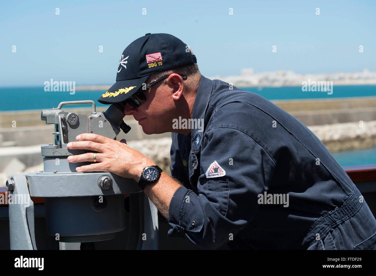 150722-N-TC720-131 Rota, Spain (July 22, 2015) Cmdr. Charles E. Hampton, commanding officer of the guided-missile destroyer USS Donald Cook (DDG 75), uses a telescopic alidade on a bridge wing of USS Donald Cook. Donald Cook is conducting naval operations in the U.S. 6th Fleet area of operations in support of U.S. national security interests in Europe.  (U.S. Navy photo by Mass Communication Specialist 3rd Class Mat Murch /Released) Stock Photo