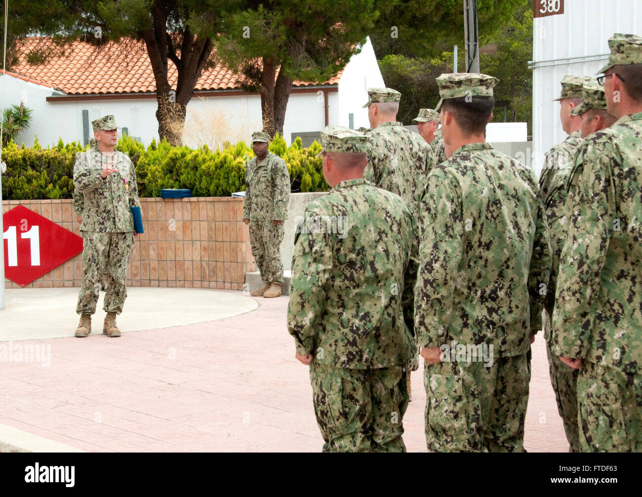 150803-N-VJ282-065 NAVAL STATION ROTA, Spain (August 3, 2015) Cmdr. Jorge Cuadros, commanding officer, Naval Mobile Construction Battalion (NMCB) 11, speaks to service members assigned to the unit during a turnover ceremony between NMCB 11 and NMCB 1 at Naval Station Rota, Spain, August 3, 2015. The turnover marked the beginning of the NMCB 1 deployment to Rota’s Seabee camp, Camp Mitchell. U.S. 6th Fleet, headquartered in Naples, Italy, conducts the full spectrum of joint and naval operations, often in concert with allied, joint, and interagency partners, in order to advance U.S. national int Stock Photo