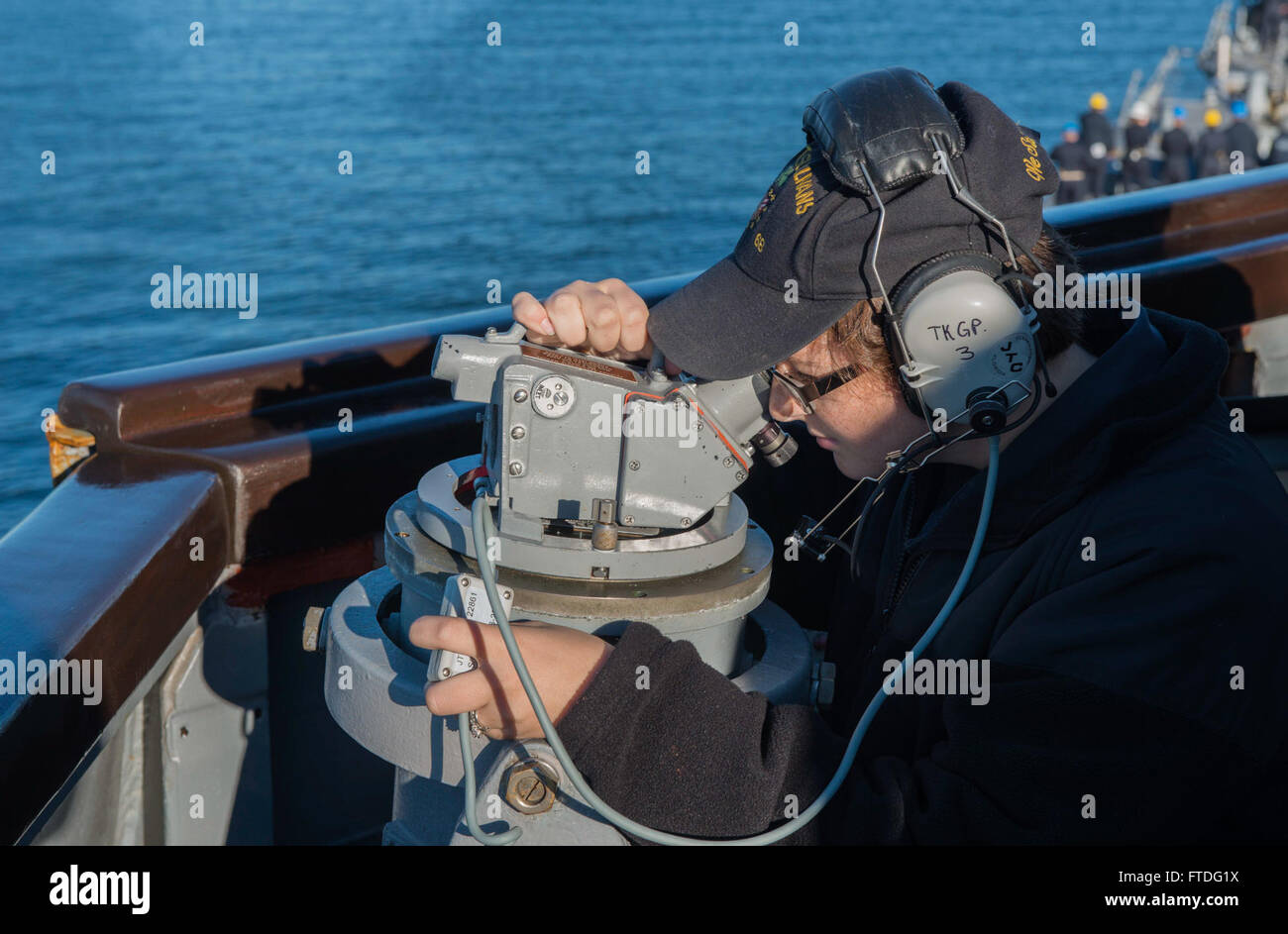 151001-N-OX430-073 FASLANE, SCOTLAND (Oct. 1, 2015) Quartermaster Seaman Recruit Kristeen Hicks looks through a telescopic alidade as the Arleigh Burke-class guided-missile destroyer USS The Sullivans (DDG 68) enters Her Majesty’s Naval Base Clyde in Faslane, Scotland. The Sullivans is in Scotland to participate in Joint Warrior, a United Kingdom-led, multinational cooperative training exercise designed to prepare NATO and allied forces for global operations. (U.S. Navy photo by Mass Communication Specialist Seaman Daniel Gaither/Released) Stock Photo