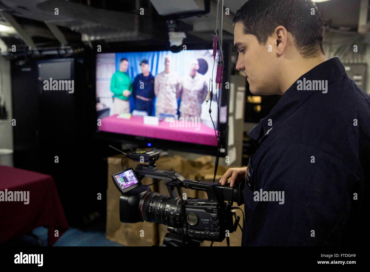 151017-N-KW492-173 ATLANTIC OCEAN (Oct. 17, 2015) Mass Communication Specialist 2nd Class Travis Diperna, from Pittsburgh, films a shipwide live TV broadcast aboard the amphibious assault ship USS Kearsarge (LHD 3) Oct. 17, 2015. Kearsarge, deployed as part of the Kearsarge Amphibious Ready Group, is conducting naval operations in the U.S. 6th Fleet area of operations in support of U.S. national security interests in Europe. (U.S. Navy Photo by Mass Communication Specialist Seaman Apprentice Ryre Arciaga/Released) Stock Photo