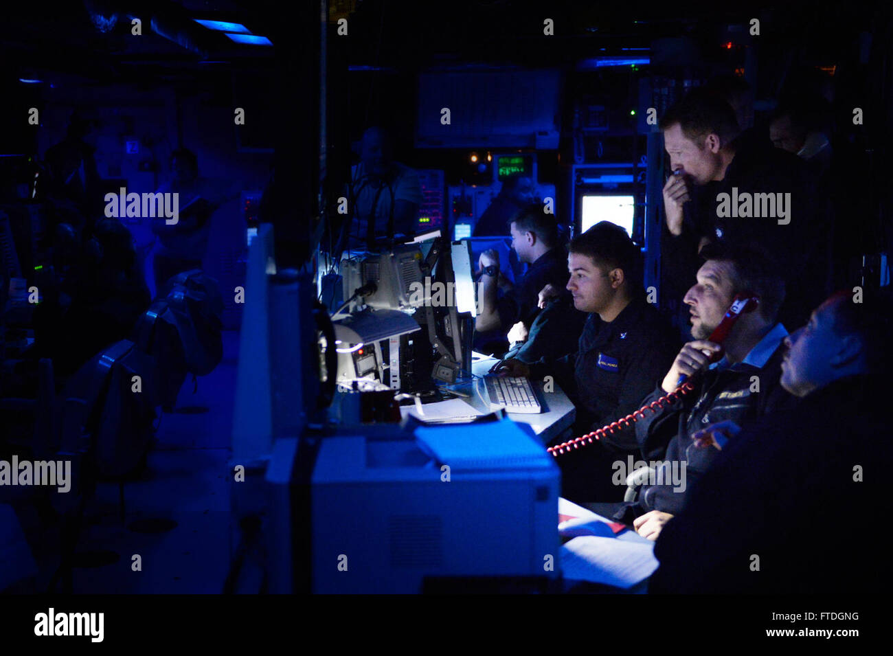 151020-N-XT273-046 ATLANTIC OCEAN (Oct. 20, 2015) Sailors aboard the Arleigh Burke-class destroyer USS Ross (DDG 71) monitor message traffic in the combat information center during the Maritime Theater Missile Defense (MTMD) Forum's at Sea Demonstration (ASD-15). Ships from Canada, France, Italy, The Netherlands, Norway, Spain, United Kingdom, and the United States tracked and destroyed target ballistic and anti-ship cruise missiles during the demonstration's six-live fire scenarios. Germany provided personnel to the multi-national Combined Task Group staff. (U.S. Navy photo by Mass Communicat Stock Photo