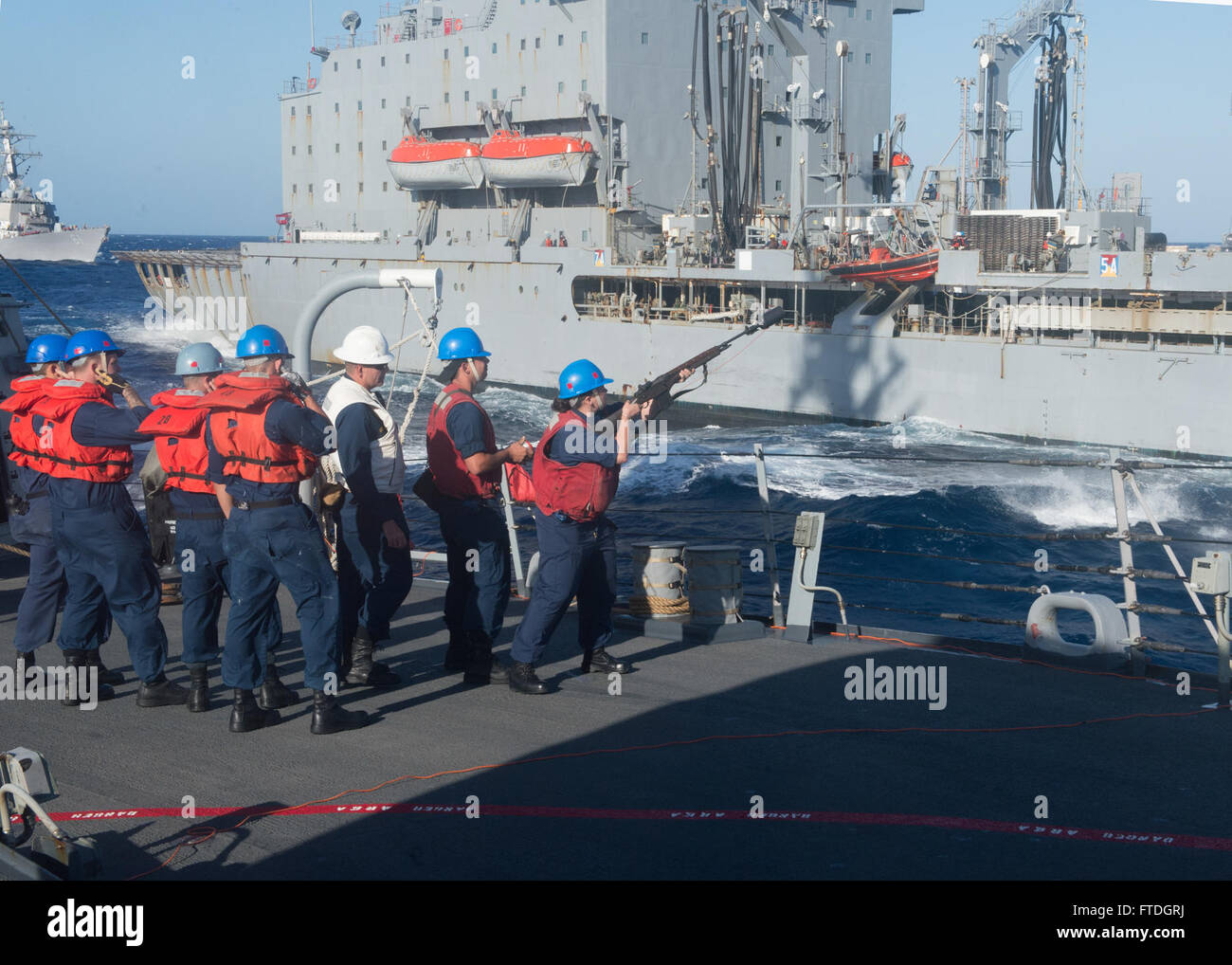 131009-N-UD469-262: MEDITERRANEAN SEA (Oct. 9, 2013) - Sailors fire a shot line from the Arleigh Burke-class guided-missile destroyer USS Stout (DDG 55) to the Military Sealift Command fleet replenishment oiler USNS Laramie (T-AO 203) during a replenishment-at-sea. Stout, homeported in Norfolk, Va., is on a scheduled deployment supporting maritime security operations and theater security cooperation efforts in the U.S. 6th Fleet area of operation. (U.S. Navy photo by Mass Communication Specialist 2nd Class Amanda R. Gray/Released) Stock Photo