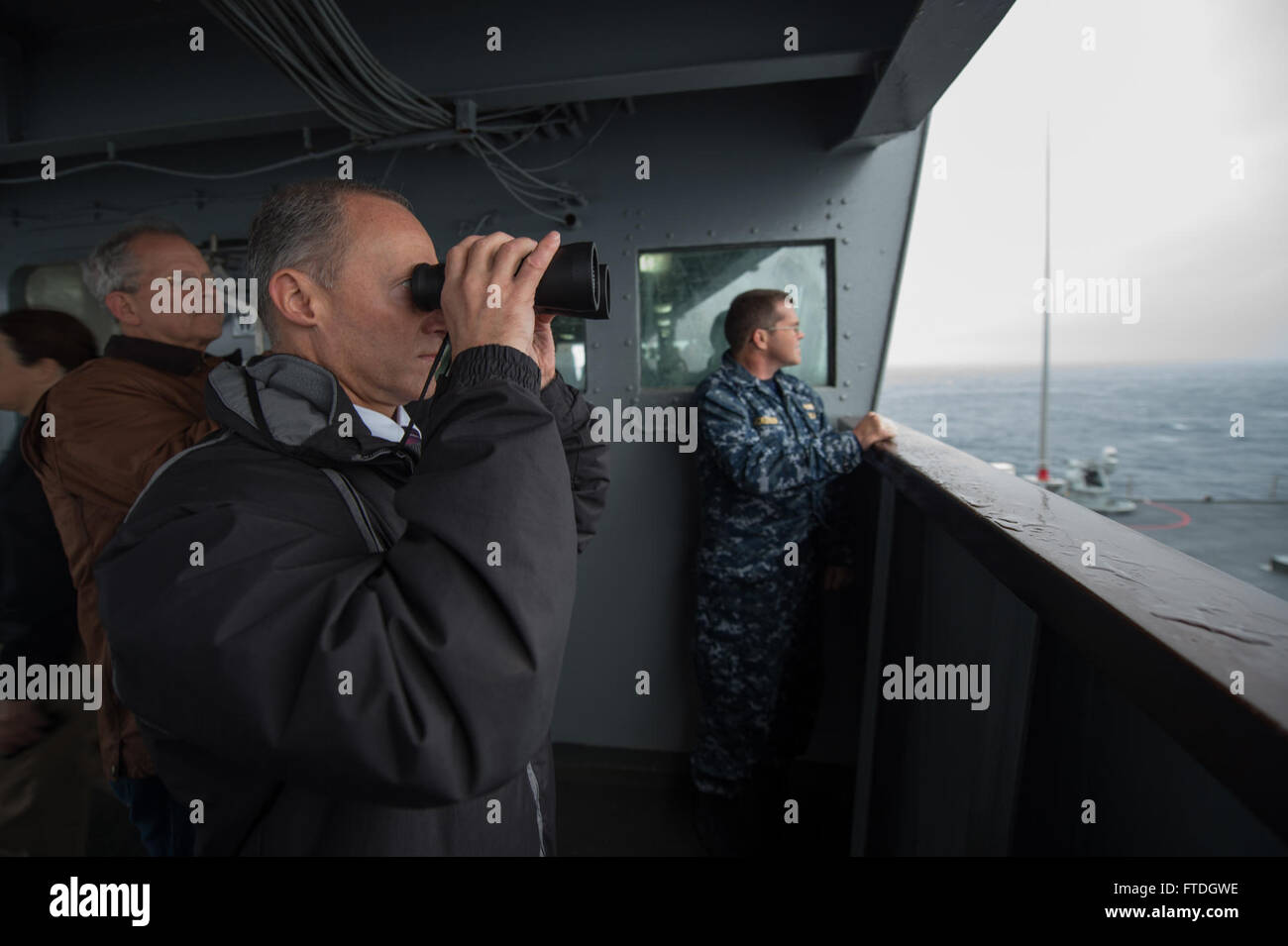151020-N-ZE250-120 NORTH ATLANTIC OCEAN (Oct. 20, 2015) Robert G. Bell, senior civilian representative of the Secretary of Defense in Europe, observes a missile launch while aboard U.S. 6th Fleet command and control ship USS Mount Whitney (LCC 20) October 20, 2015. Mount Whitney hosted distinguished visitors for the Maritime Theater Missile Defense forum's At Sea Demonstration 2015. (U.S. Navy photo by Mass Communication Specialist 3rd Class Weston Jones/Released) Stock Photo