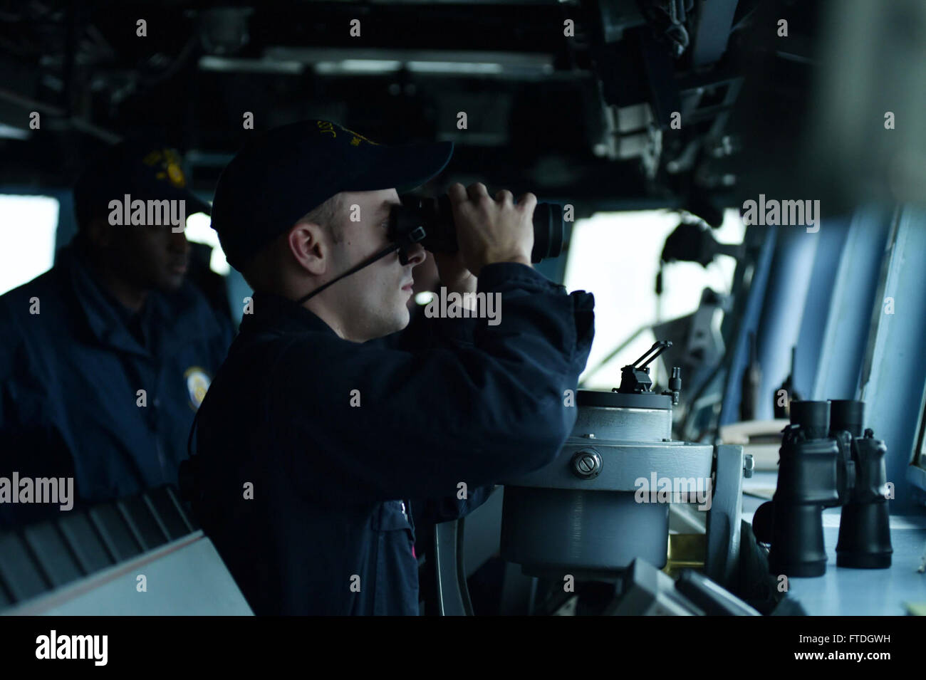 151020-N-XT273-413 ATLANTIC OCEAN (Oct. 20, 2015) Ensign Sean Mansfield checks for a clear range during the Maritime Theater Missile Defense (MTMD) Forum's at Sea Demonstration (ASD-15) aboard the Arleigh Burke-class destroyer USS Ross (DDG 71). Ships from Canada, France, Italy, The Netherlands, Norway, Spain, United Kingdom, and the United States tracked and destroyed target ballistic and anti-ship cruise missiles during the demonstration's six-live fire scenarios. Germany provided personnel to the multi-national Combined Task Group staff. (U.S. Navy photo by Mass Communication Specialist 2nd Stock Photo
