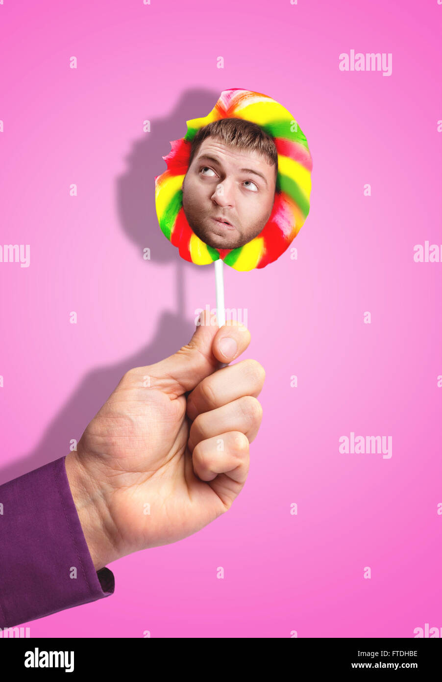 Man's face in lollipop Stock Photo