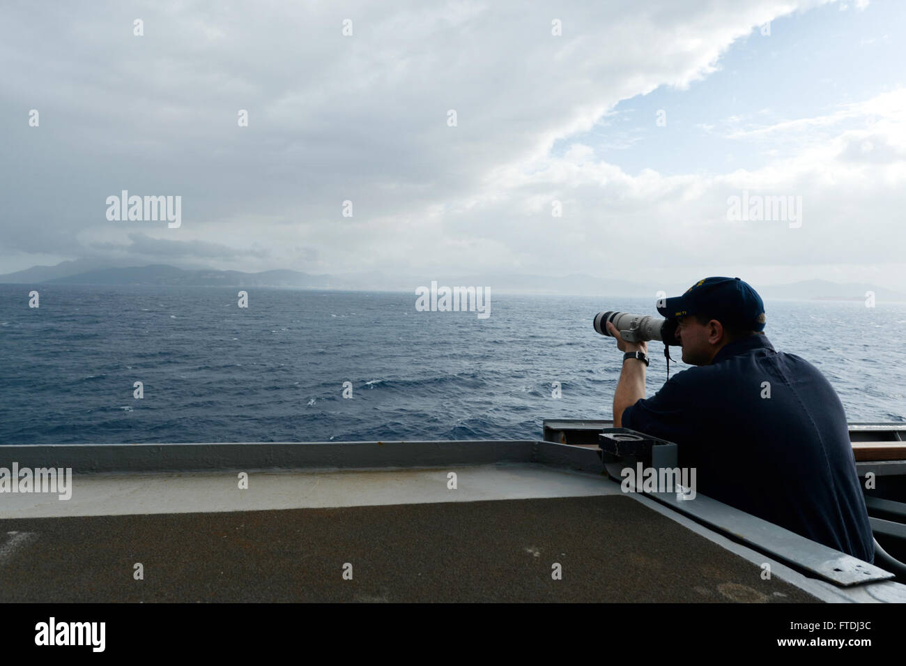 151121-N-XT273-619 STRAIT of GIBRARLTAR (Nov. 21, 2015) Intelligence Specialist 1st Class James Friederichs takes photos while on Ship's Nautical or Otherwise Photographic Intelligence Exploitation team aboard the Arleigh Burke-class destroyer USS Ross (DDG 71) during transit through the Strait of Gibraltar Nov. 21, 2015. Ross is conducting naval operations in the U.S. 6th Fleet area of operations in support of U.S. national security interest in Europe. (U.S. Navy photo by Mass Communication Specialist 2nd Class Justin Stumberg/Released) Stock Photo