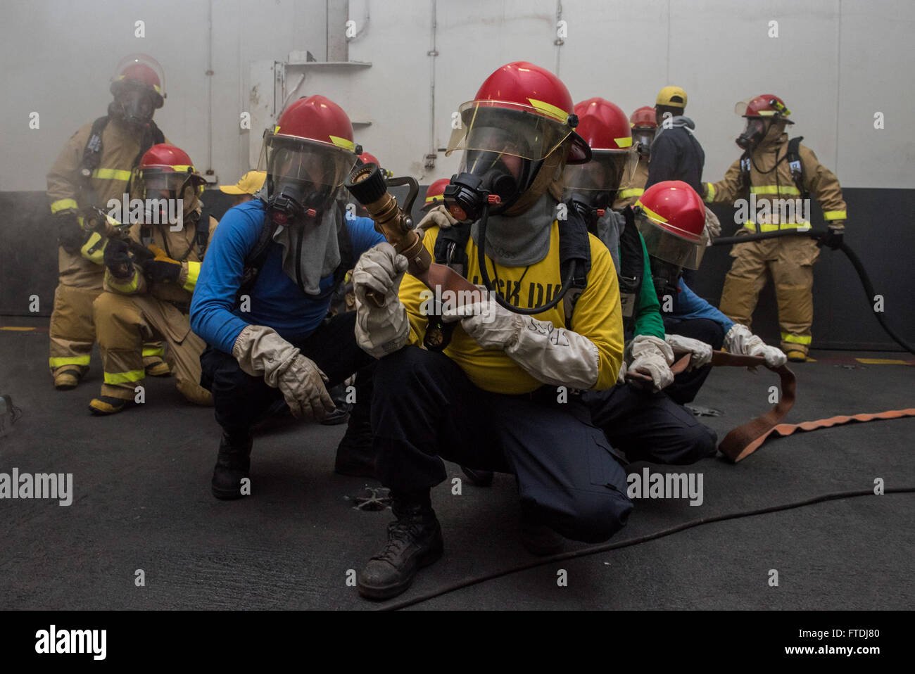 151128-N-QH848-038  ATLANTIC OCEAN (Nov. 28, 2015) Sailors fight a simulated fire during a general quarters drill in the hangar bay of aircraft carrier USS Harry S. Truman (CVN 75). GQ drills prepare Sailors to be at the highest state of readiness in the event of an emergency. Harry S. Truman Carrier Strike Group is deployed to support maritime security operations and theater security cooperation efforts in the U.S. 5th and 6th Fleet areas of operation. (U.S. Navy photo by Mass Communication Specialist 3rd Class A. A. Cruz/Released) Stock Photo