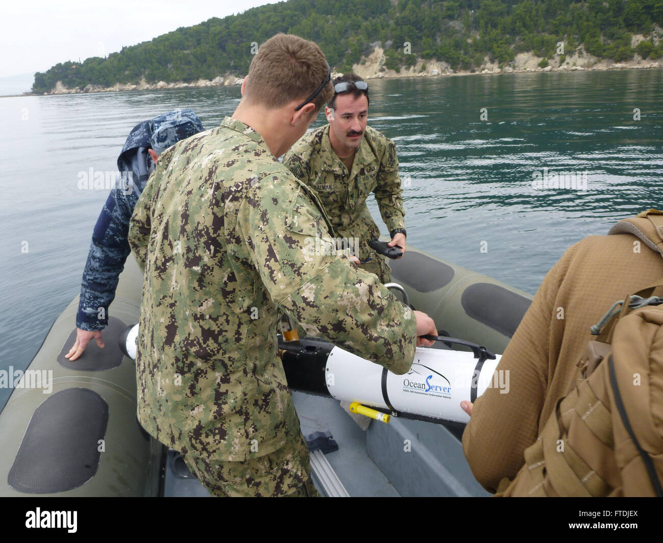 151205-N-XX888-003 SPLIT, Croatia (Dec. 5, 2015) Explosive Ordnance Disposal Technician 2nd Class Matt Volar, left, and Explosive Ordnance Disposal Technician 2nd Class Dan Salman, assigned to Explosive Ordnance Disposal Mobile Unit 8, and Croatian divers recover the IVER-3 UUV Dec. 5, 2015. U.S. 6th Fleet, headquartered in Naples, Italy, conducts the full spectrum of joint and naval operations, often in concert with allied, joint, and interagency partners, in order to advance U.S. national interests and security and stability in Europe and Africa. (U.S. Navy photo by Lt. Jonathan Dobbins/ Rel Stock Photo