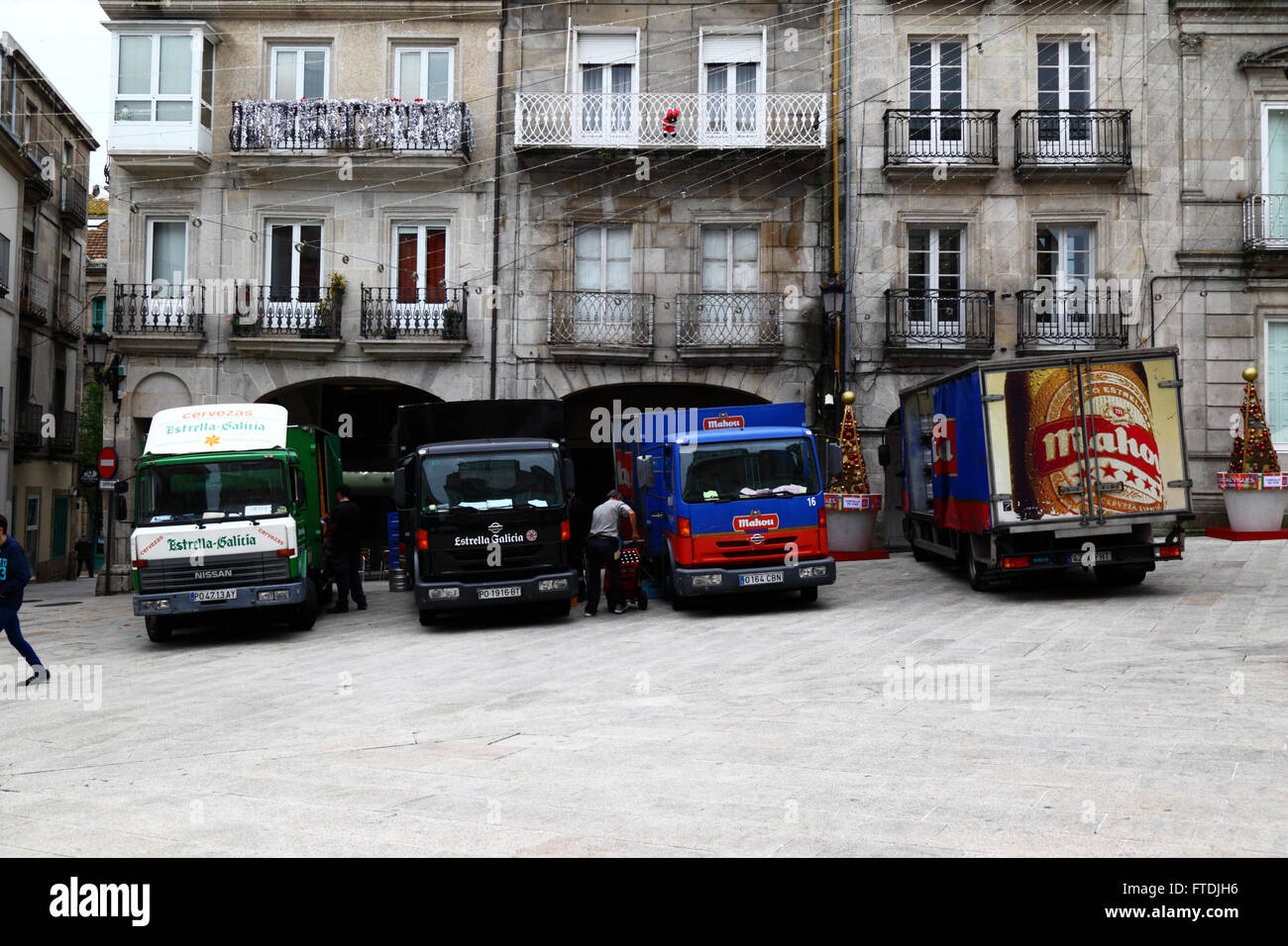 Beer delivery trucks parked in Praza da Constitucion, Casco Viejo, Vigo, Galicia, Spain Stock Photo