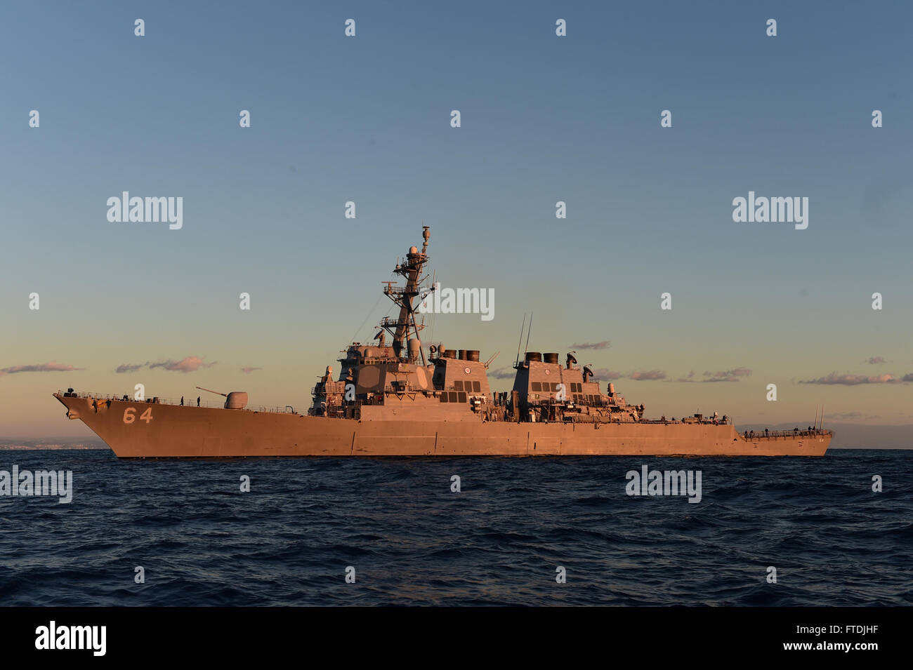 151206-N-FP878-121 MEDITERRANEAN SEA (Dec. 6, 2015). USS Carney (DDG 64) awaits the return of its small boat crew during a passenger transfer Dec. 6, 2015.  Carney, an Arleigh Burke-class guided missile destroyer, forward deployed to Rota, Spain, is conducting a routine patrol in the U. S. 6th Fleet area of operations in support of U.S. national security interests in Europe.  (U.S. Navy photo by Mass Communication Specialist 1st Class Theron J. Godbold/Released) Stock Photo