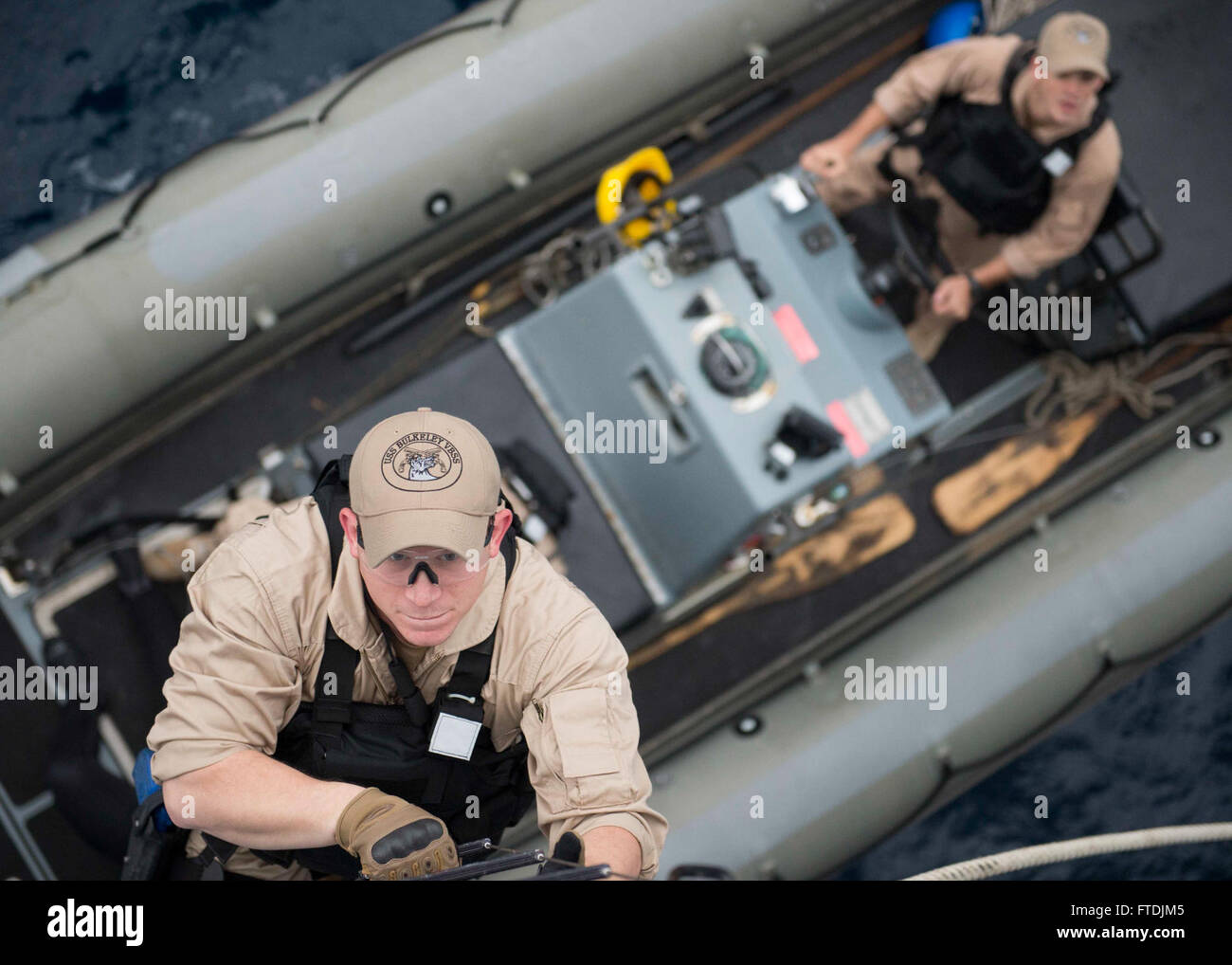151209-N-AO823-118 MEDITERRANEAN SEA (Dec. 9, 2015) -- Fire Controlman 2nd Class E. Roys climbs aboard guided-missile destroyer USS Bulkeley (DDG 84) from a rigid hull inflatable boat during a visit, board, search and seizure training exercise. Bulkeley, part of the Harry S. Truman Carrier Strike Group, is conducting naval operations in the U.S. 6th Fleet area of operations in support of U.S. national security interests in Europe and Africa. (U.S. Navy photo by Mass Communication Specialist 2nd Class M.J. Lieberknecht/Released) Stock Photo