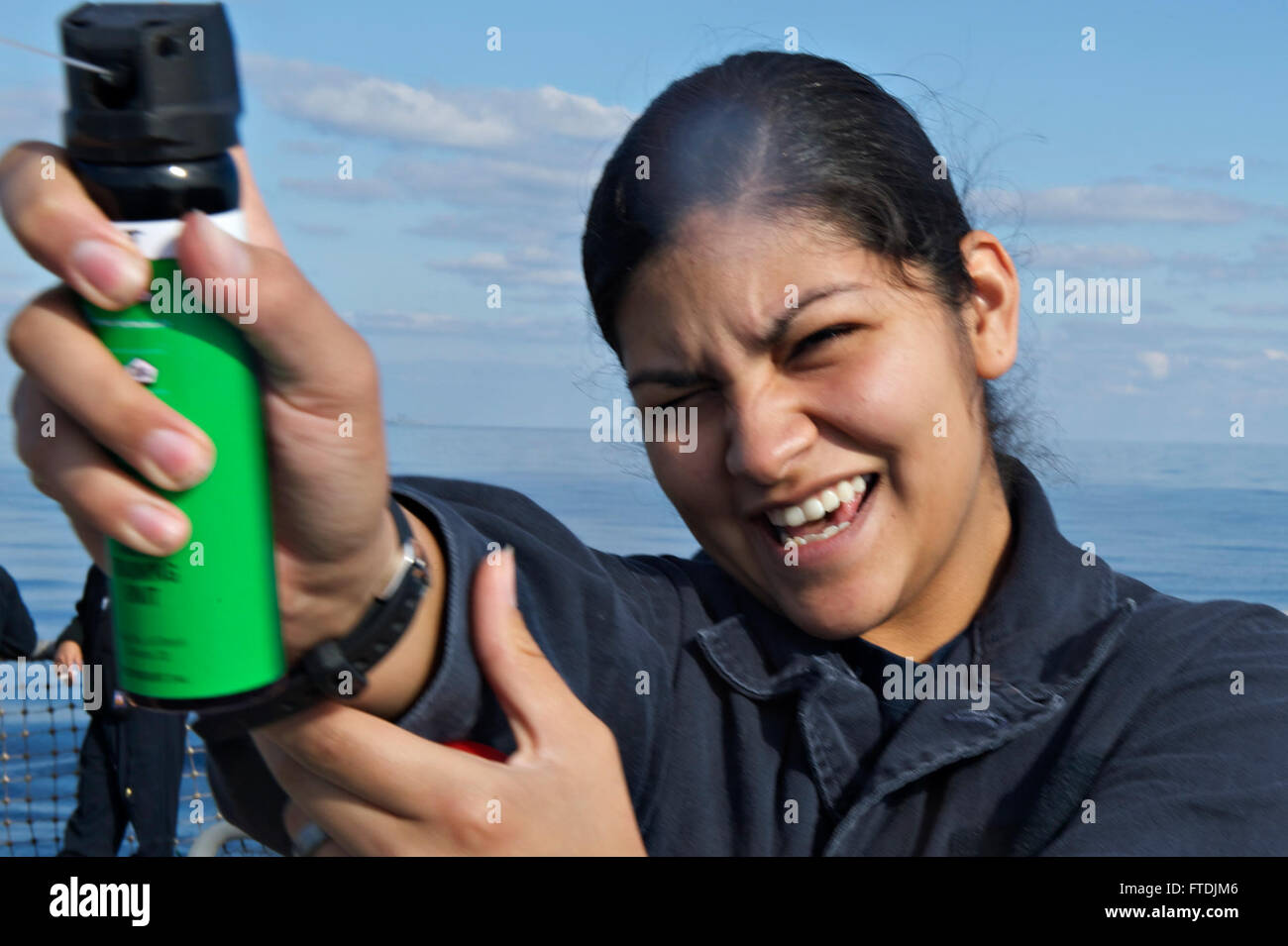 151209-N-FP878-377 MEDITERRANEAN SEA (Dec. 9, 2015) Seaman Lisette Longoria from San Antonio, Texas, sprays inert practice OC pepper spray during security forces sentry training aboard USS Carney (DDG 64) Dec. 9, 2015. Carney, an Arleigh Burke-class guided missile destroyer, forward deployed to Rota, Spain, is conducting a routine patrol in the U. S. 6th Fleet area of operations in support of U.S. national security interests in Europe. (U.S. Navy photo by Mass Communication Specialist 1st Class Theron J. Godbold/Released) Stock Photo