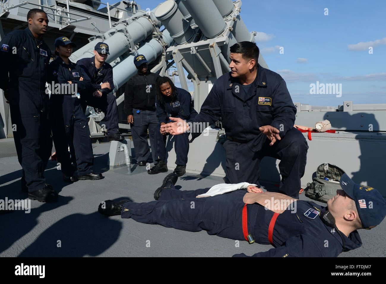 151209-N-FP878-381 MEDITERRANEAN SEA (Dec. 9, 2015) Senior Chief Hospital Corpsman Noel Martinez from San Diego, second from right, gives basic first aid training to Sailors aboard USS Carney (DDG 64) Dec. 9, 2015. Carney, an Arleigh Burke-class guided-missile destroyer, forward deployed to Rota, Spain, is conducting a routine patrol in the U. S. 6th Fleet area of operations in support of U.S. national security interests in Europe. (U.S. Navy photo by Mass Communication Specialist 1st Class Theron J. Godbold/Released) Stock Photo