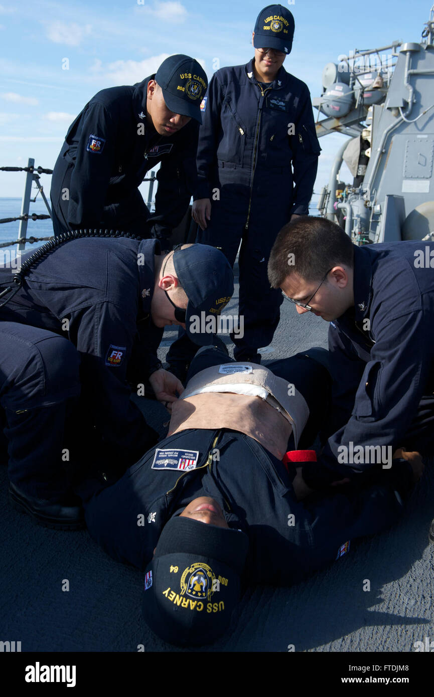151209-N-FP878-381 MEDITERRANEAN SEA (Dec. 9, 2015) Sailors aboard USS Carney (DDG 64) practice basic first aid Dec. 9, 2015. Carney, an Arleigh Burke-class guided-missile destroyer, forward deployed to Rota, Spain, is conducting a routine patrol in the U. S. 6th Fleet area of operations in support of U.S. national security interests in Europe. (U.S. Navy photo by Mass Communication Specialist 1st Class Theron J. Godbold/Released) Stock Photo