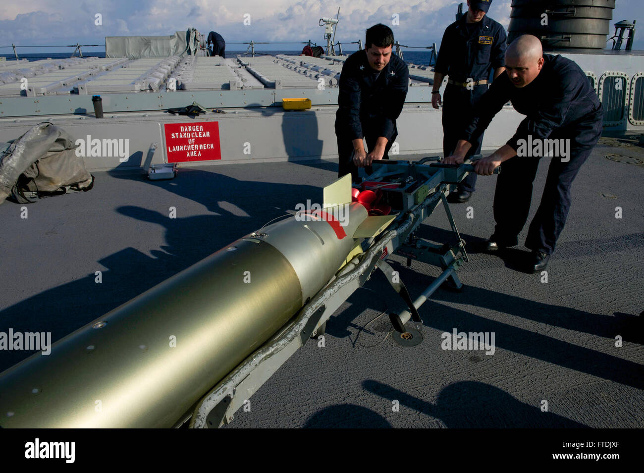 Sailors aboard the USS Carney (DDG 64), an Arleigh Burke-class ...